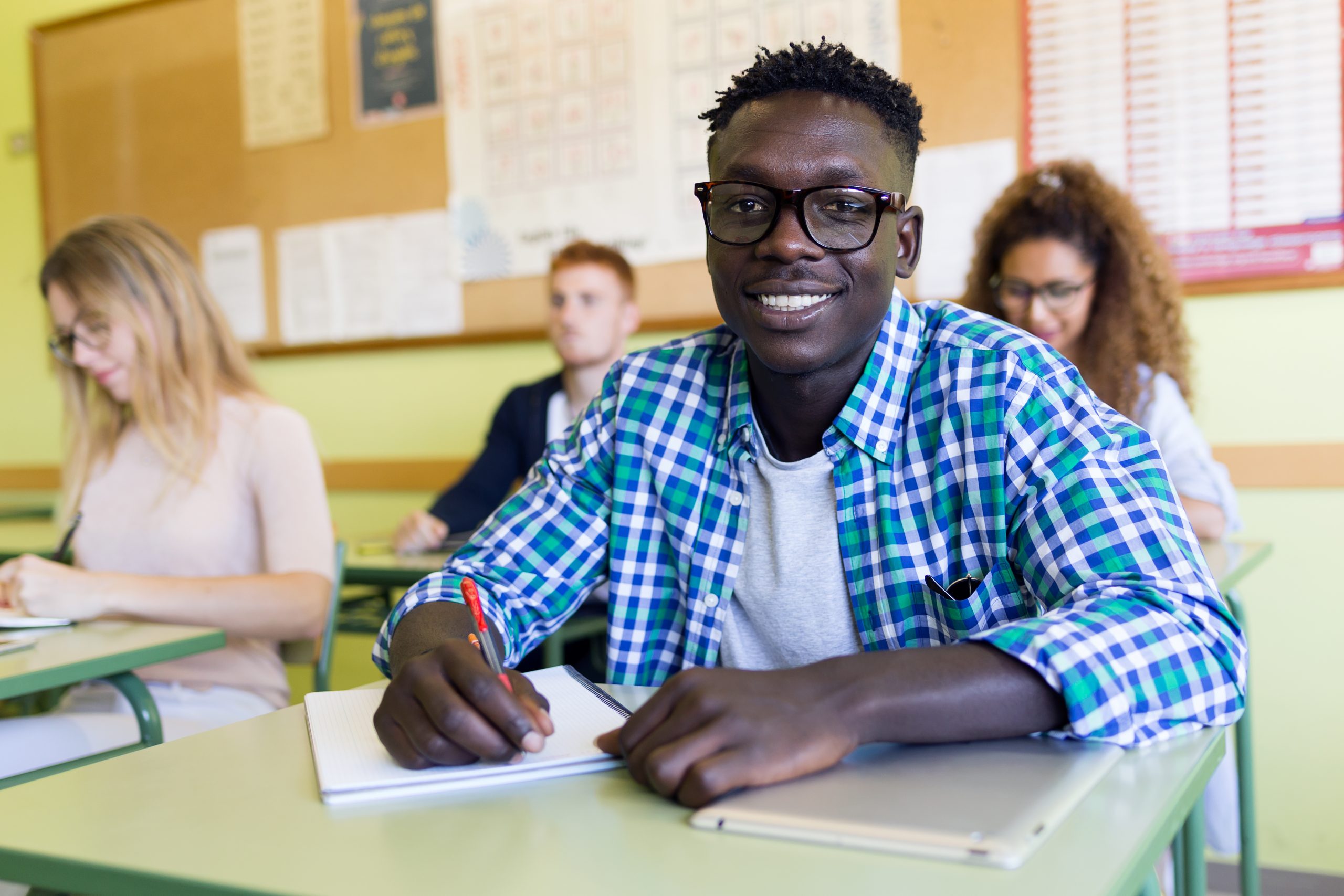 Portrait of group of friends studying in a university classroom.