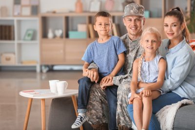 Happy military man with his family at home