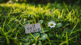 self care day note on a green meadow