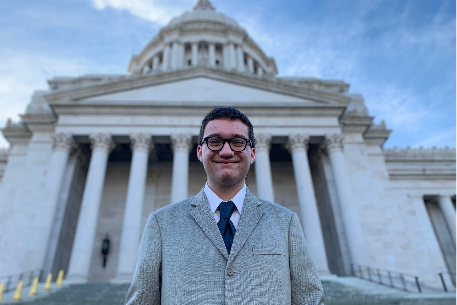 Youth Poses in front of the Capitol in Olympia WA