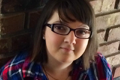 Young Lady looking up with a confident smile